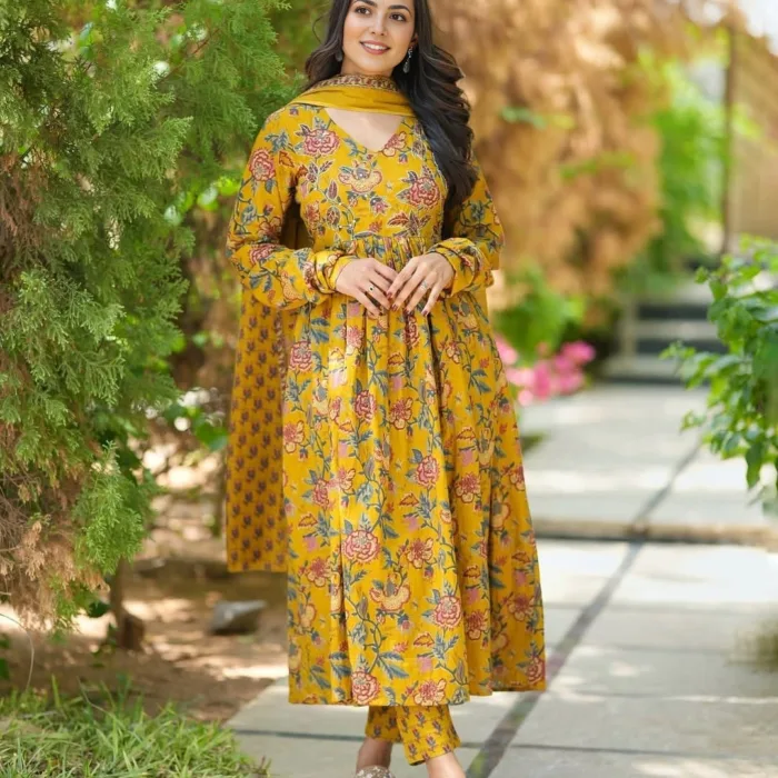 Embrace timeless elegance in this mustard yellow floral Anarkali cotton suit set adorned with charming floral prints. Tailored in breathable cotton fabric, this 3-piece ensemble includes a flared kurta, matching straight pants, and a printed dupatta – ideal for summer brunches, festive celebrations, or ethnic day wear.