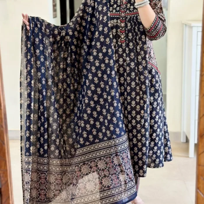 A timeless navy blue cotton suit set featuring delicate beige floral motifs, enhanced with detailed printed yoke and sleeves. The set includes a flowy A-line kurta, matching straight pants, and a beautifully bordered printed dupatta. A must-have for your casual ethnic wardrobe or breezy daywear.
