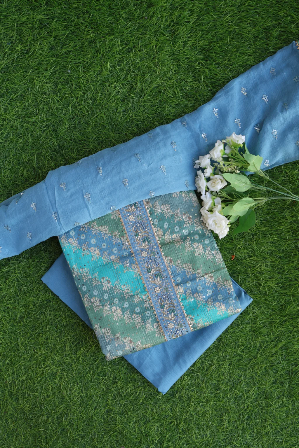 Discover our luxurious Blue-Green Unstitched Suit Set with dazzling sequin work. Perfect for festive and party wear. Shop this stunning ethnic dress material today!