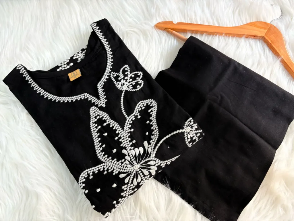 Black cotton suit set with white floral thread embroidery – elegant stitched ethnic wear for women.