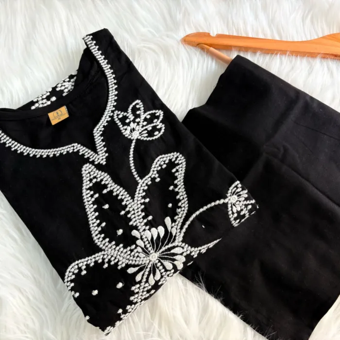 Black cotton suit set with white floral thread embroidery – elegant stitched ethnic wear for women.