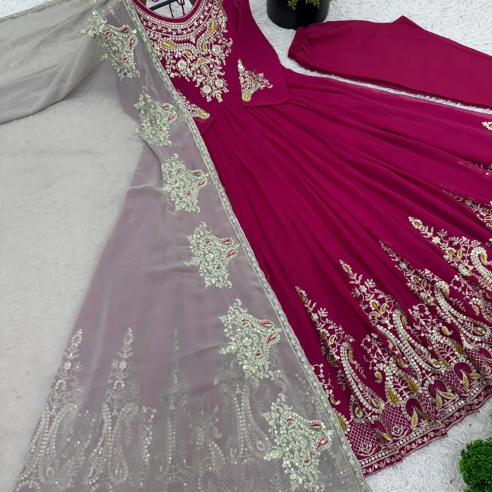 Unleash timeless grace with this show-stopping magenta Anarkali suit, exquisitely embroidered with golden motifs and paired with a dreamy beige dupatta. A perfect pick for weddings, festivals, and elegant evenings.